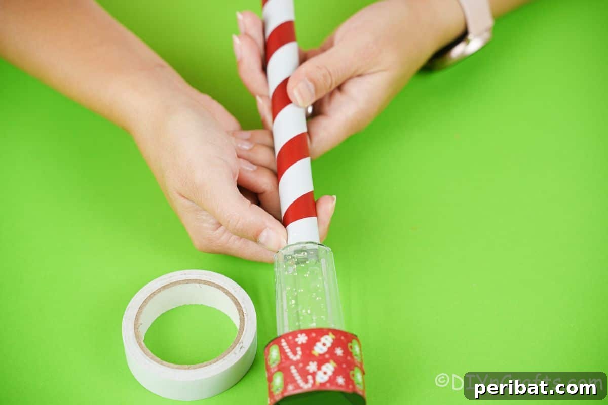 Whimsical Arctic Lamppost Craft 12 hand wrapping white and red tape around base of solar light