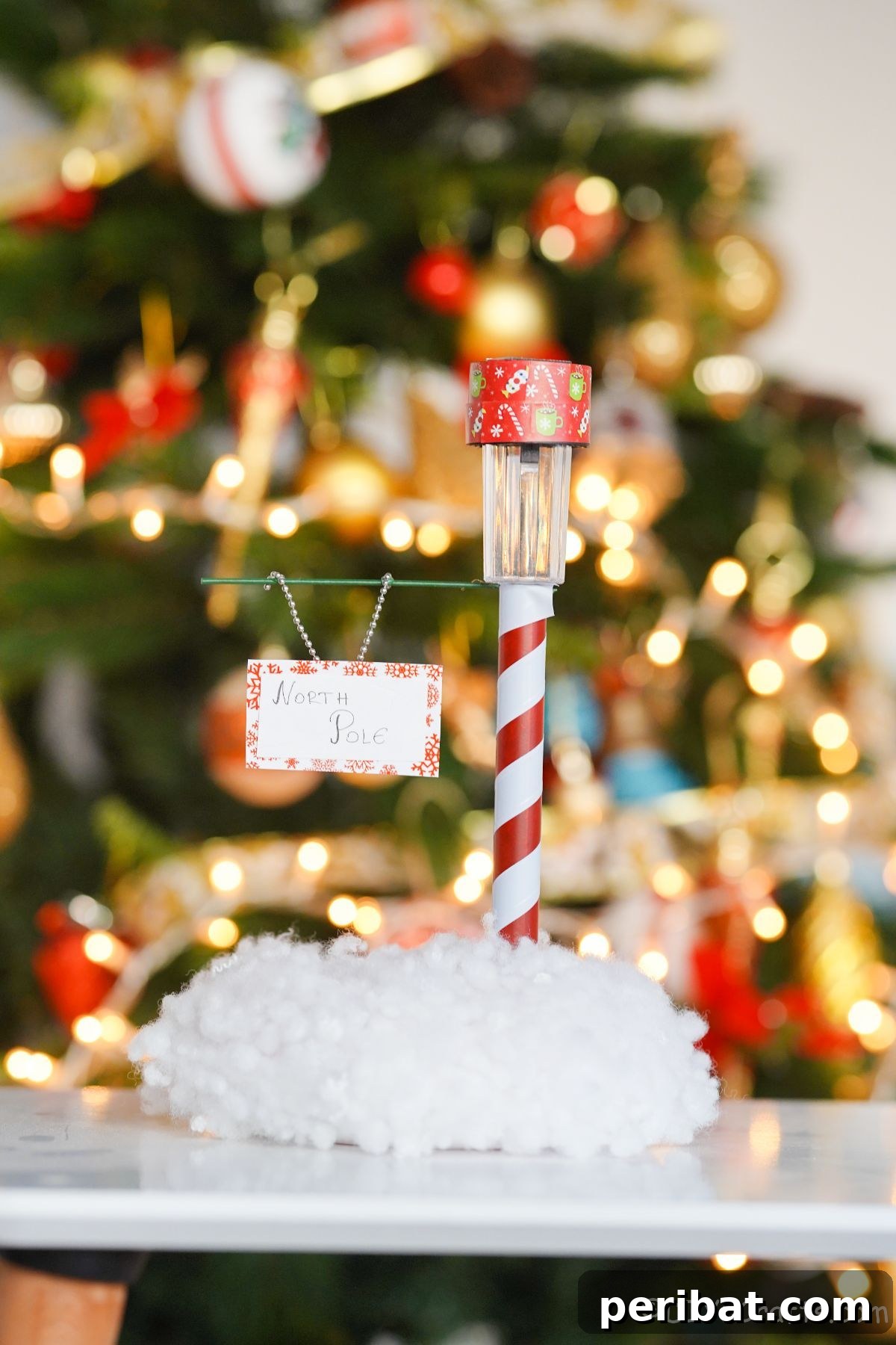 Whimsical Arctic Lamppost Craft 21 mini north pole sign on white table in front of Christmas tree