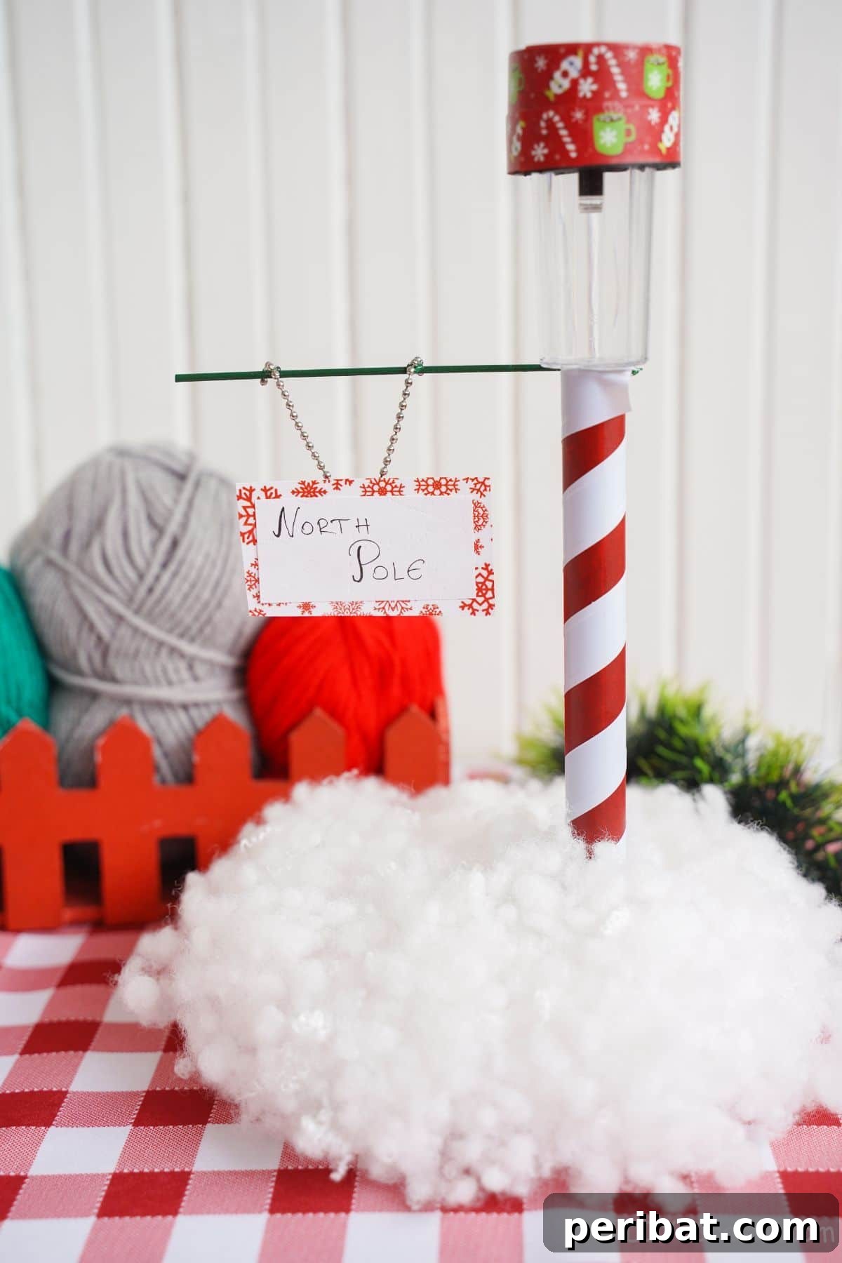 Whimsical Arctic Lamppost Craft 22 red and white checked tablecloth beneath miniature north pole sign