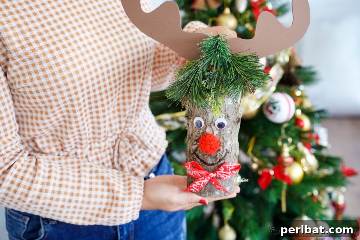Whimsical Woodland Log Reindeer Decor 15 lady holding log reindeer in front of christmas tree