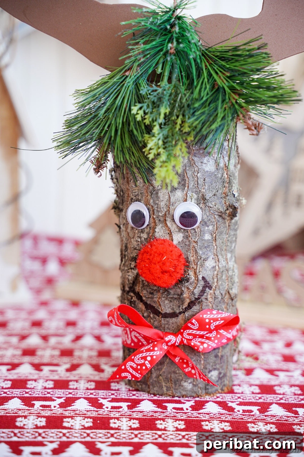 Whimsical Woodland Log Reindeer Decor 18 rustic log reindeer on table with red bow