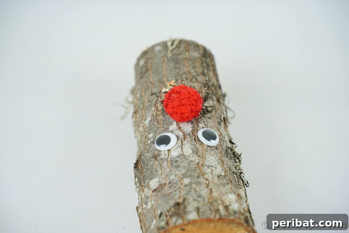 Whimsical Woodland Log Reindeer Decor 10 log on table with eyes and red pom pom nose