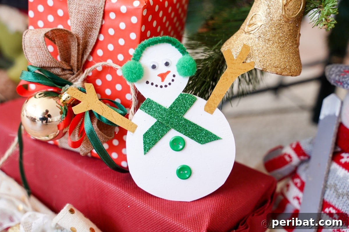 Simple Snowman Christmas Card Craft for Children 3 paper snowman on top of present