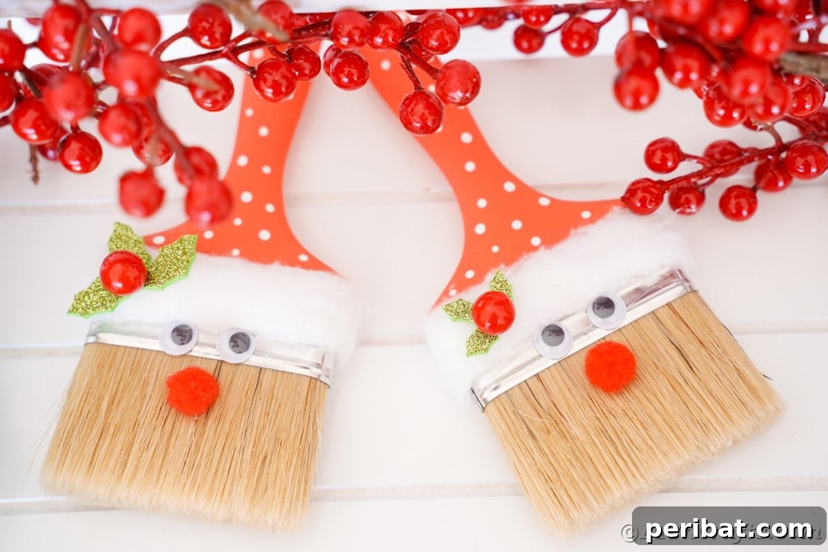 Two cheerful paintbrush Santas, painted in vibrant red and white, showcasing different sizes and expressions, ready for holiday display.