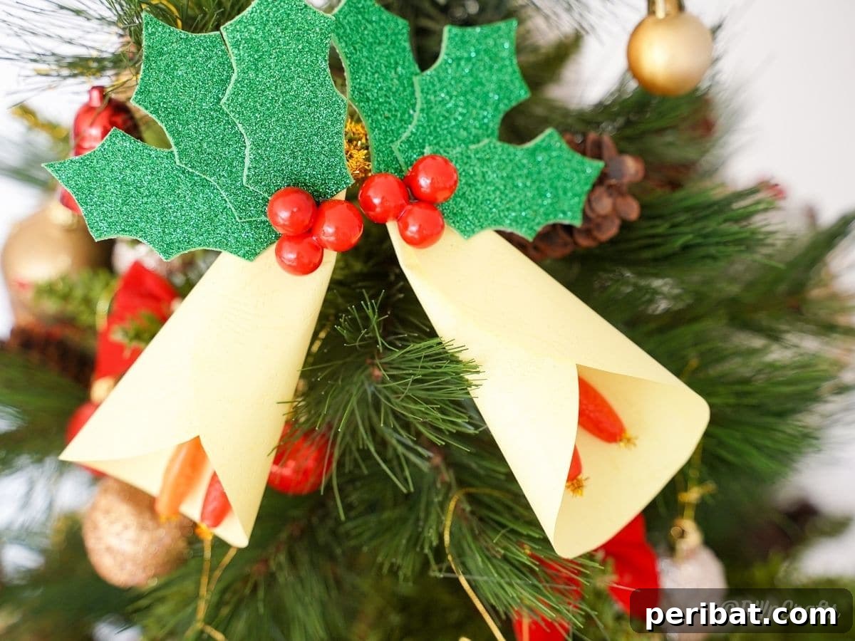 Handcrafted Paper Holly Christmas Ornament 12 holly leaf ornament on Christmas tree, in context of holiday decor