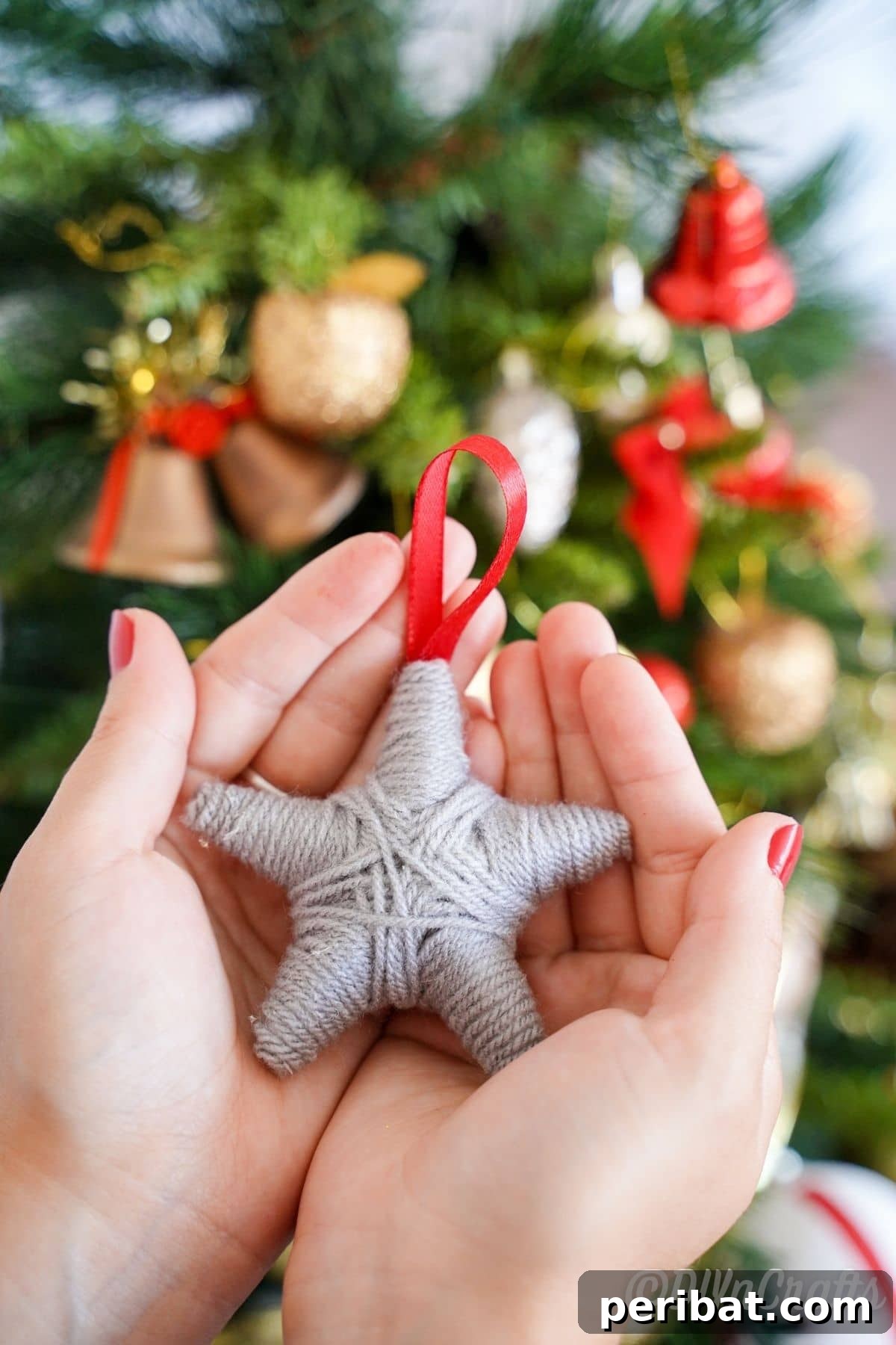 Charming Rustic Yarn Star Tree Ornament 2 womans hands holding yarn ornament