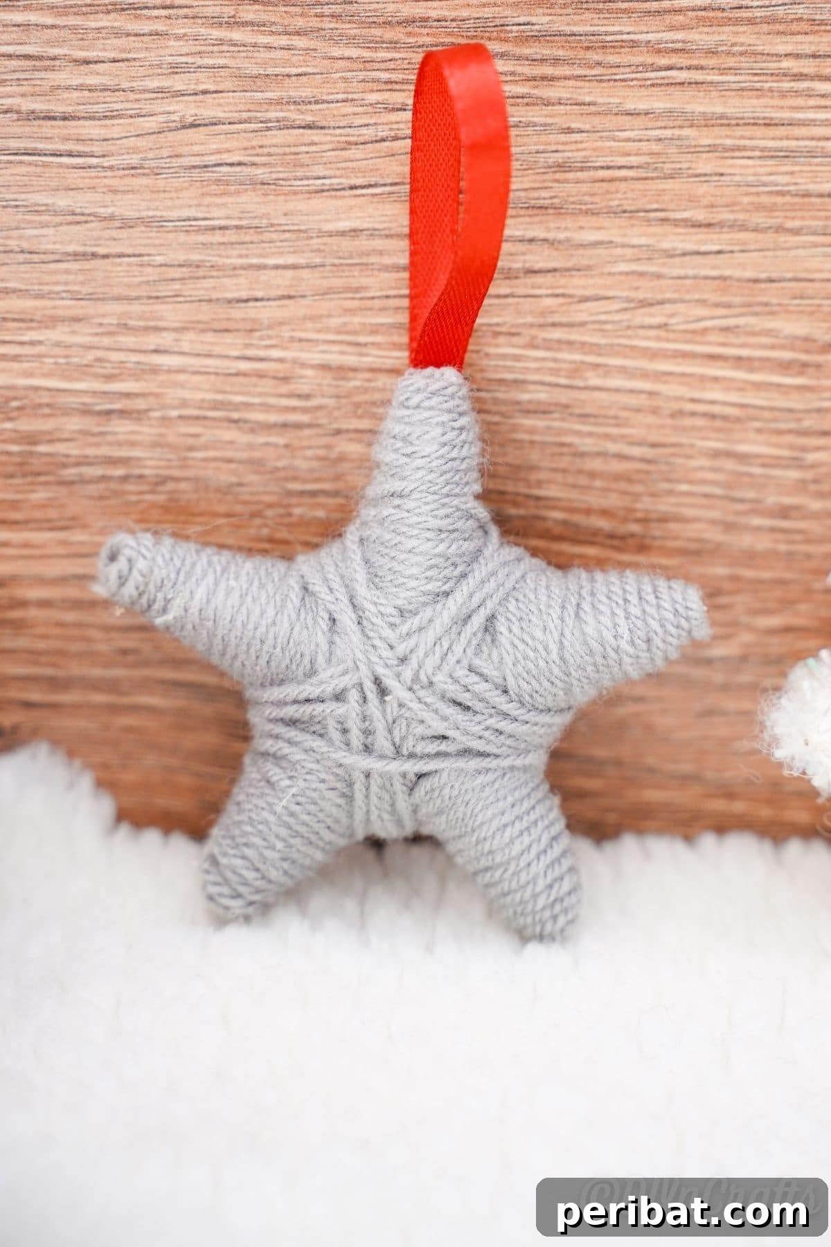 Charming Rustic Yarn Star Tree Ornament 16 yarn star ornament against wood