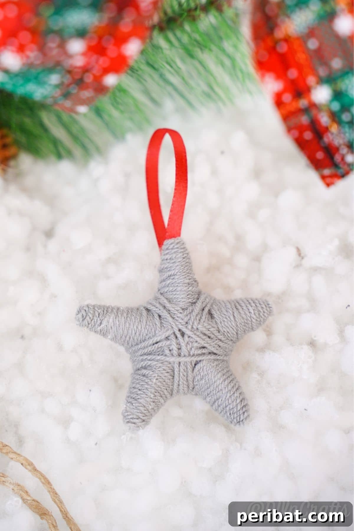 Charming Rustic Yarn Star Tree Ornament 5 gray yarn star on fake snow