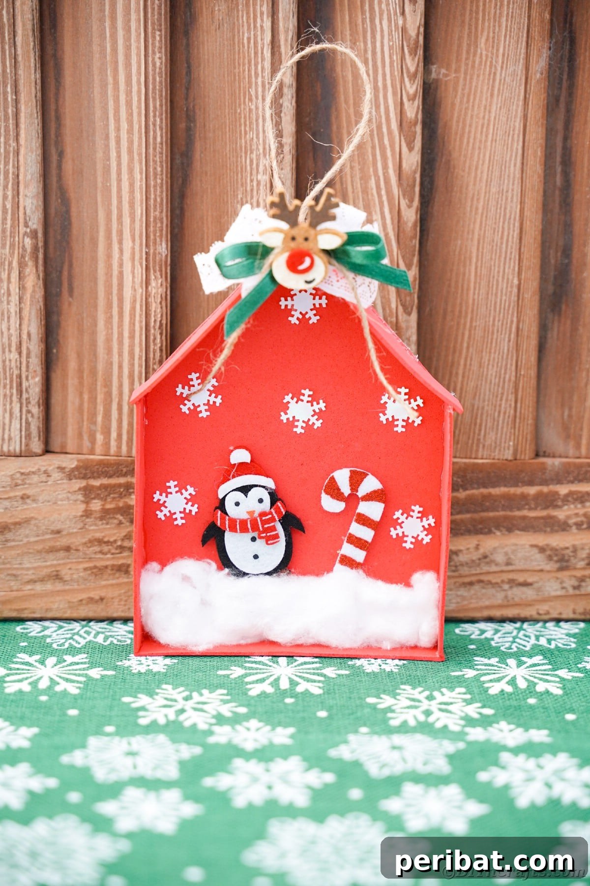 Whimsical Foam Penguin House Tree Ornament 19 A rustic wood background serving as a cozy backdrop for the red foam house ornament