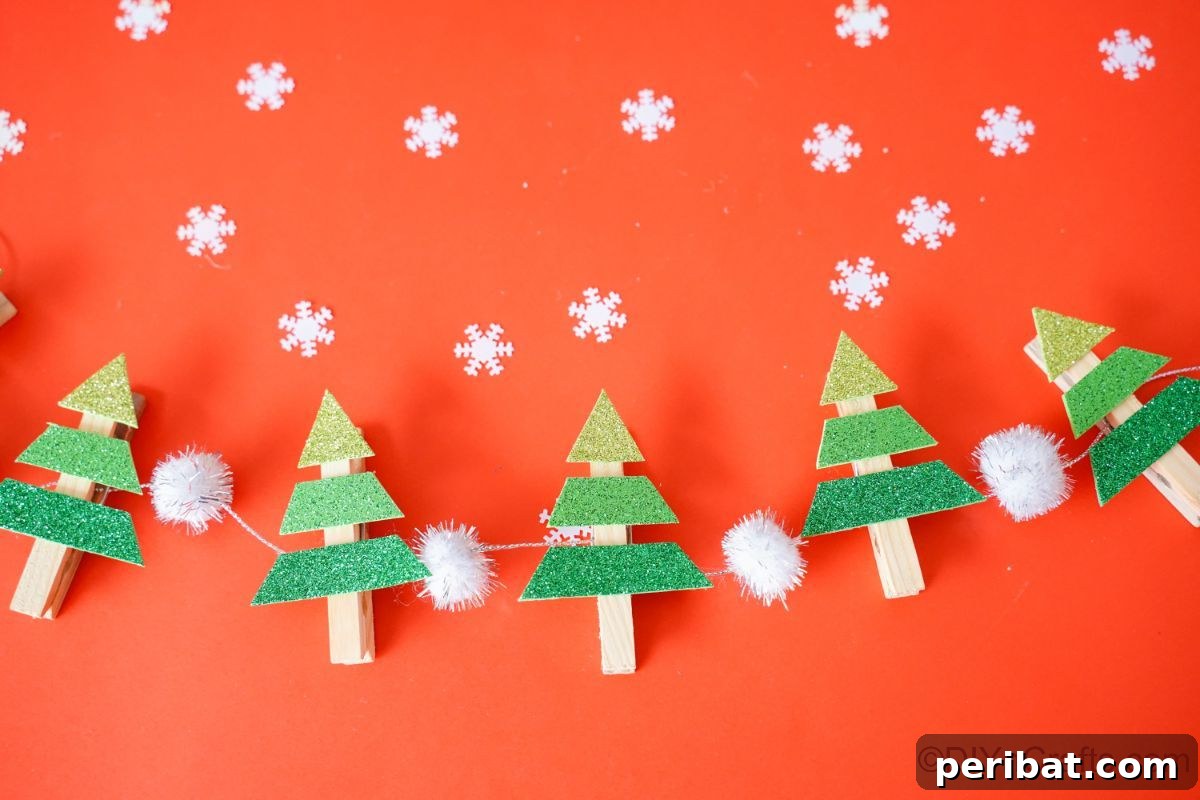 clothespin mini trees on white garland laying on red table
