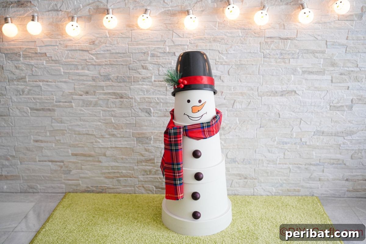 A whimsical white clay pot snowman positioned on a green rug, against a backdrop of a white brick wall