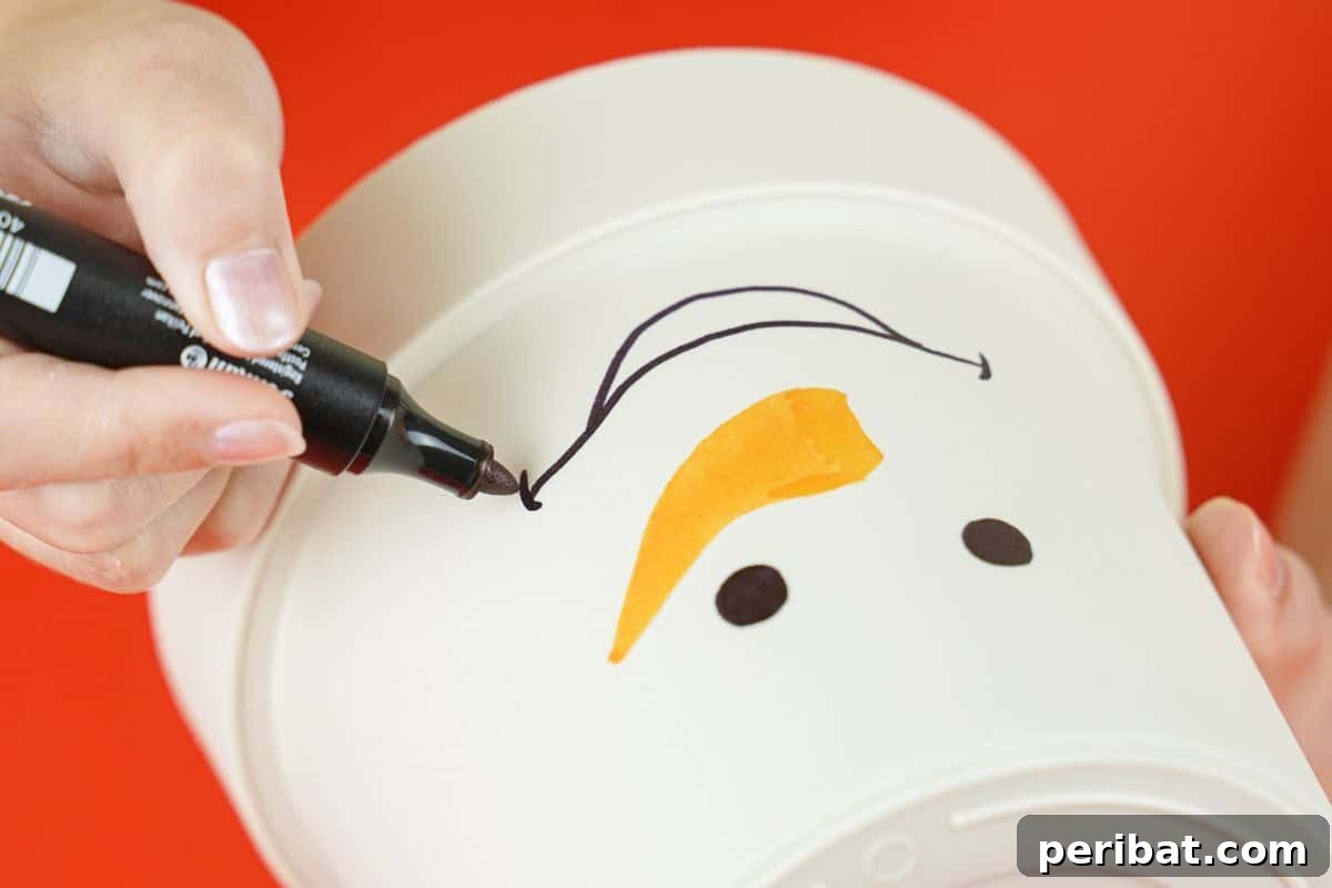Hand drawing a cheerful smile with a black marker on a white painted flower pot