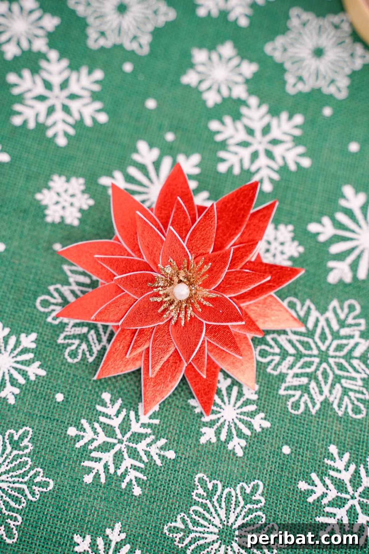 Craft Your Own Foam Poinsettia Brooch or Festive Ornament 14 Green and white snowflake paper with fake flower on top