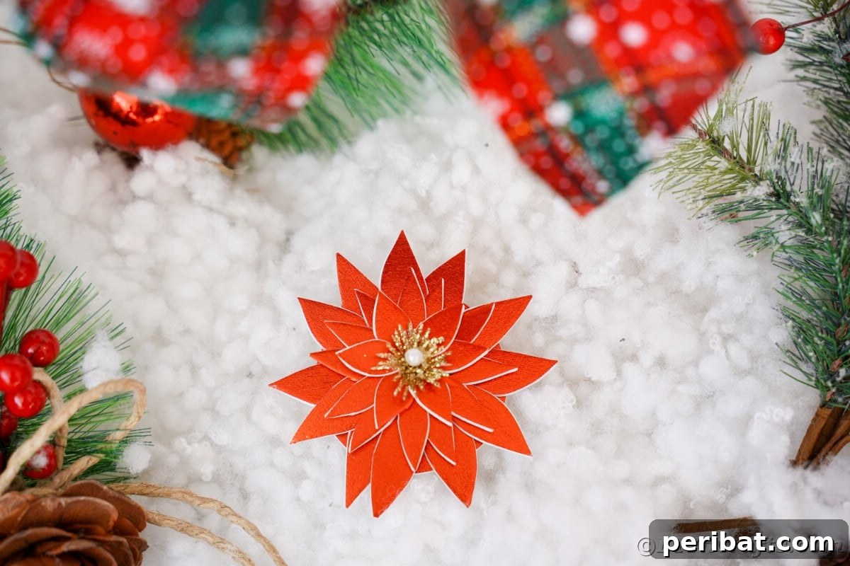 Craft Your Own Foam Poinsettia Brooch or Festive Ornament 3 Fake red foam poinsettia laying on fake snow with green and red ribbons above