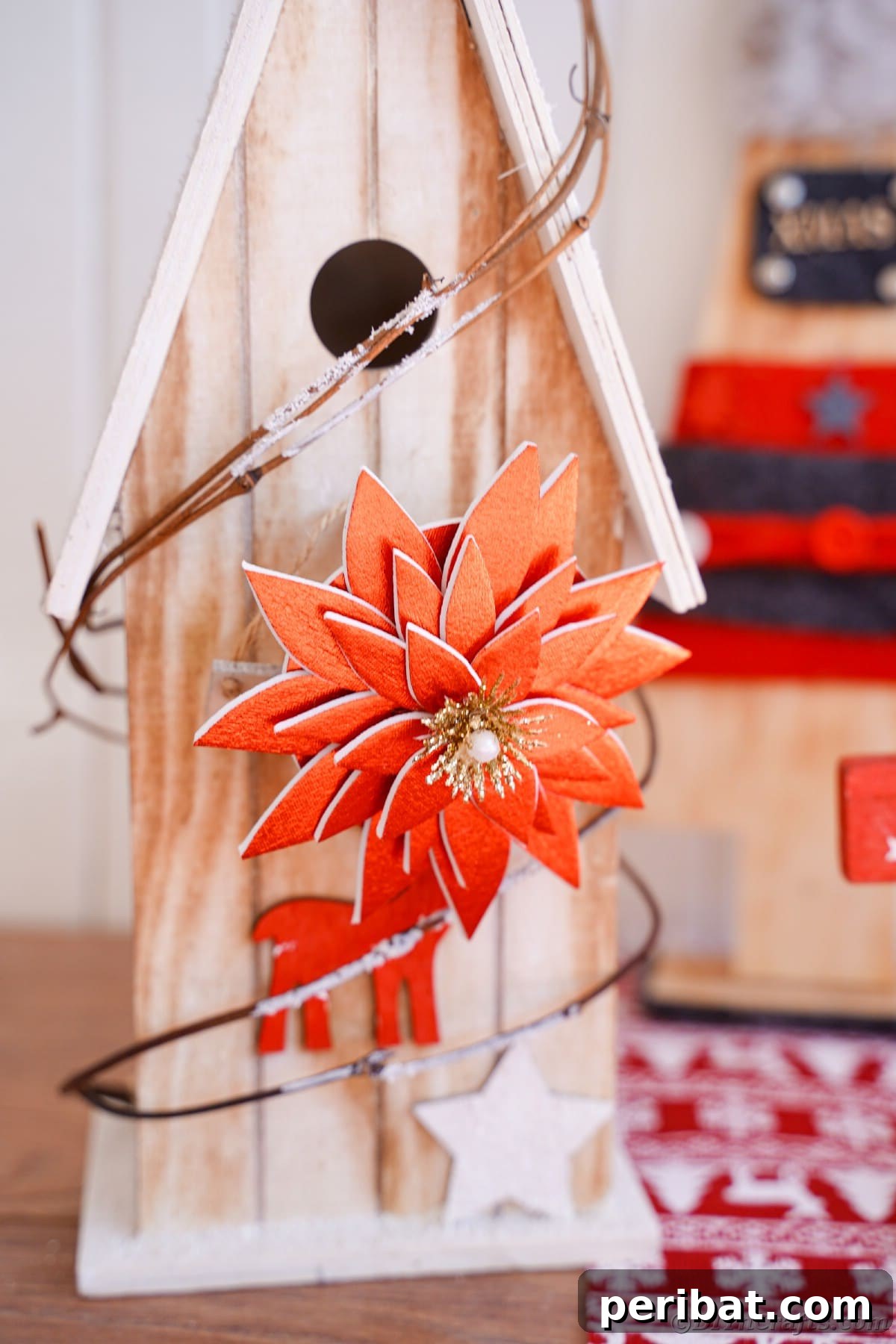 Craft Your Own Foam Poinsettia Brooch or Festive Ornament 4 Wooden birdhouse on table by holiday papers and stack of books with red foam flower on top