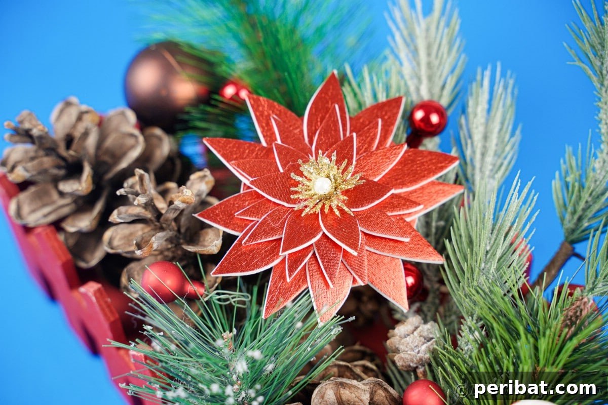Craft Your Own Foam Poinsettia Brooch or Festive Ornament 9 Red foam flower on top of pinecones and greenery in red basket on blue table