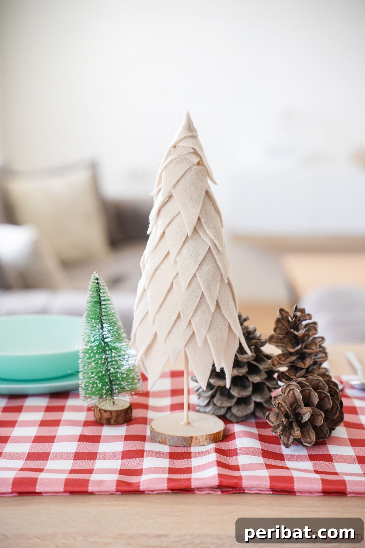 Cozy Upcycled Sweater Christmas Tree 2 red and white checked tablecloth with mini tree on top next to light teal plates