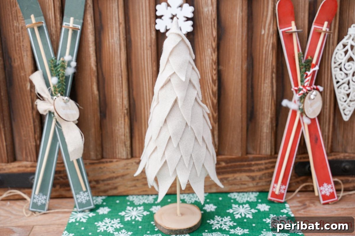 Cozy Upcycled Sweater Christmas Tree 5 mini skis against wood background with mini tree on green paper in front of wall