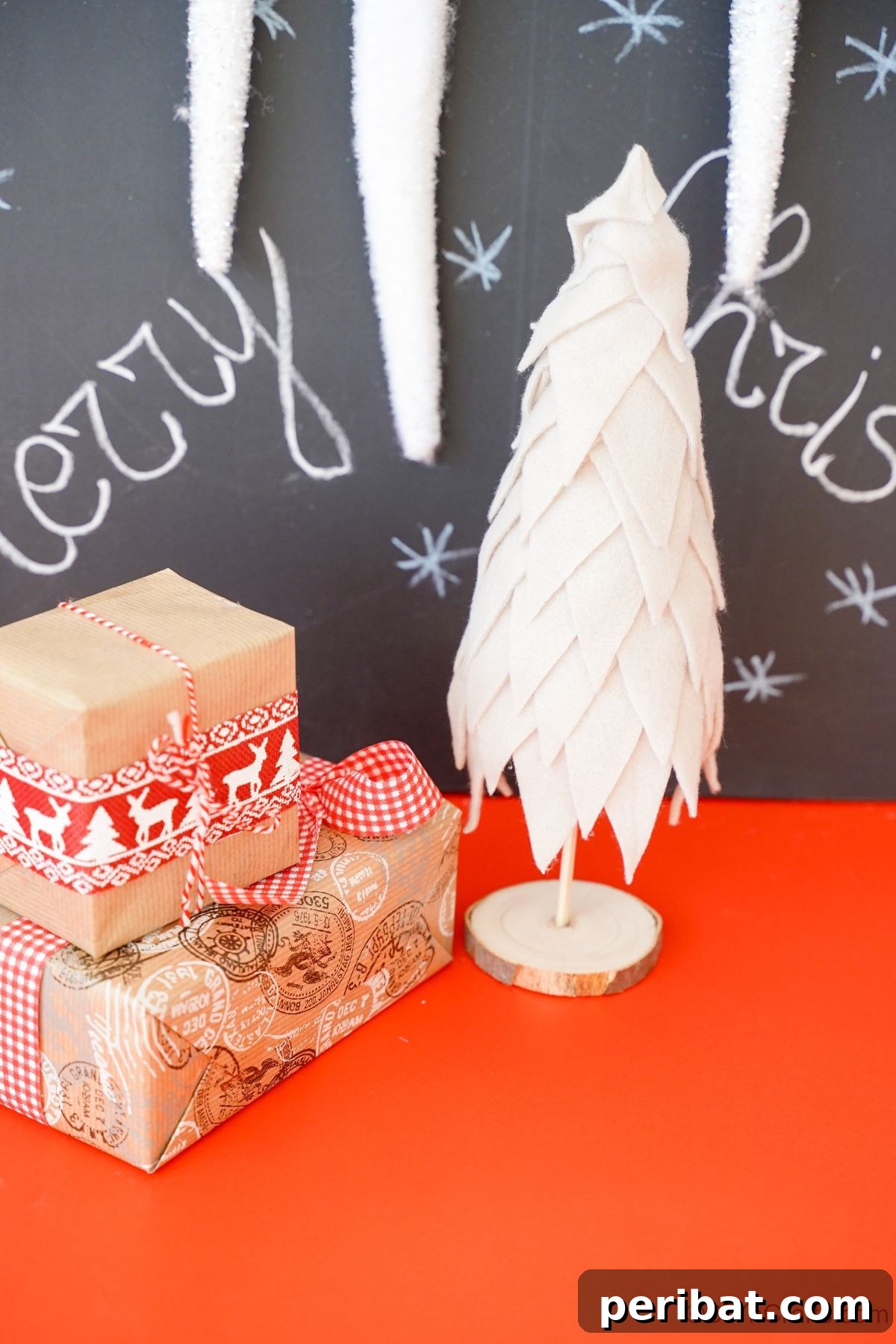 Cozy Upcycled Sweater Christmas Tree 6 cream fabric Christmas tree sitting on red table by chalkboard