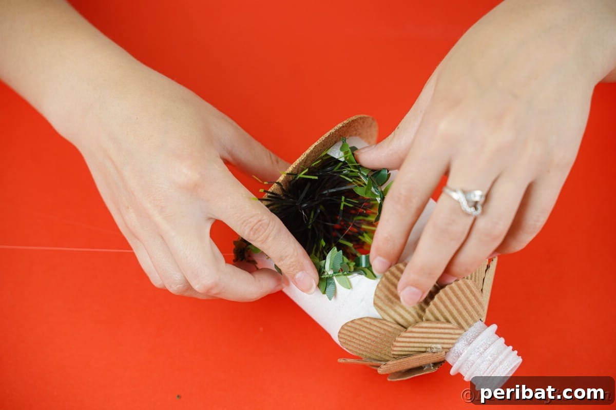 hand holding greenery on side of white bottle house