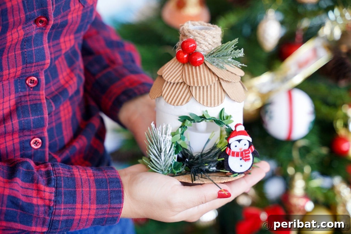 Arctic Home Crafted from Upcycled Plastic 21 lady in blue and pink plaid shirt holding miniature north pole hosue in front of Christmas tree