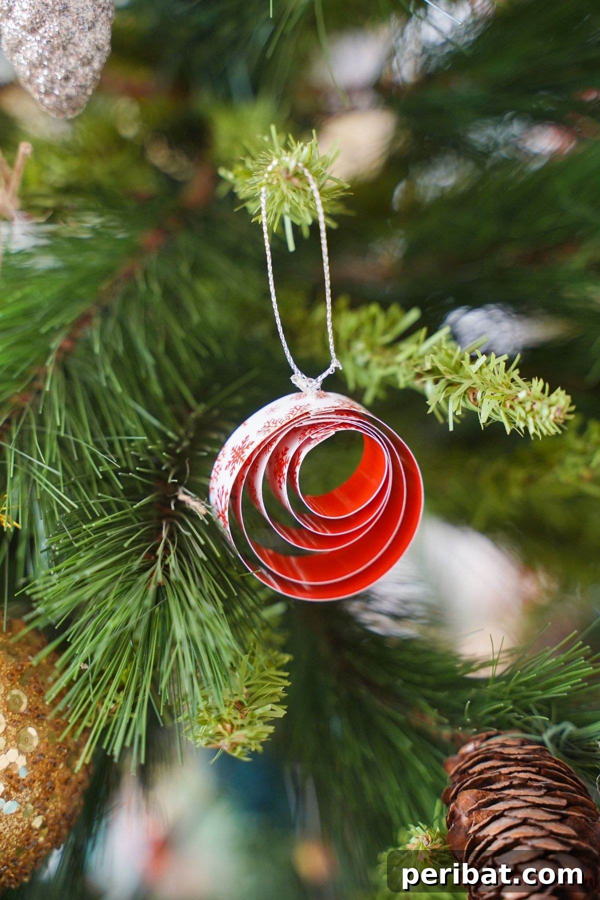 Layered Rolled Paper Christmas Charm 2 red and white paper ornament hanging on christmas tree