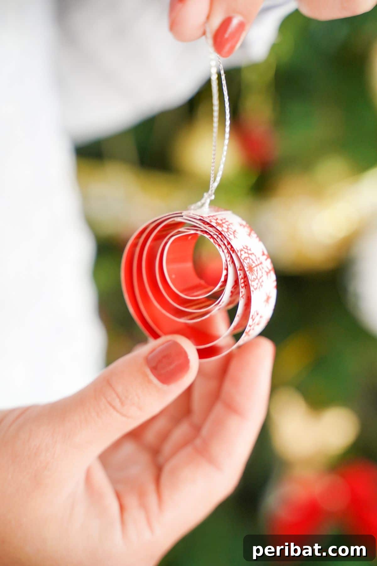 Layered Rolled Paper Christmas Charm 18 lady holding rolled paper ornament in her hand