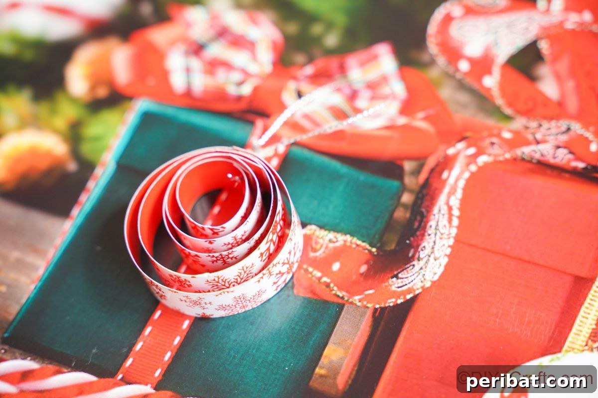 Layered Rolled Paper Christmas Charm 5 round rolled paper ornament sitting on top of christmas gift holiday paper