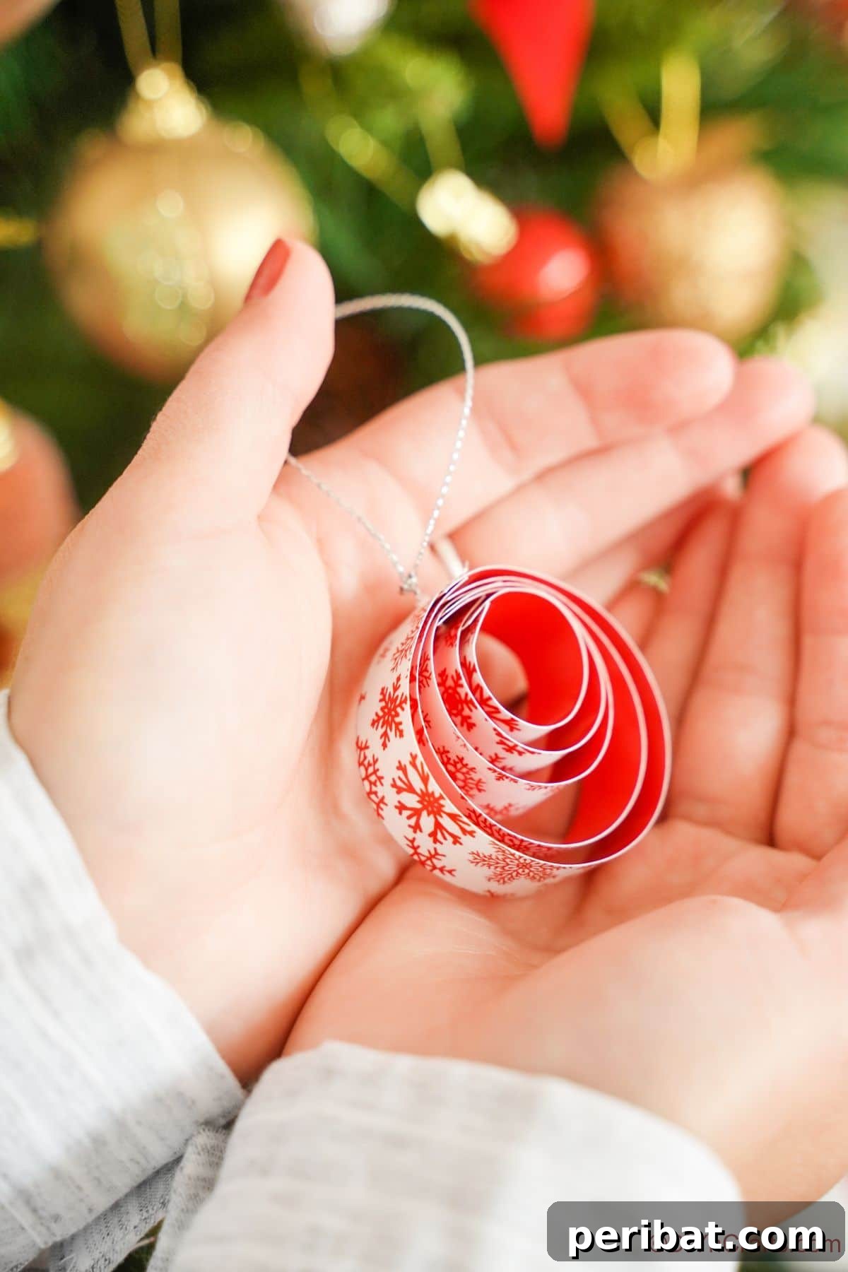 Layered Rolled Paper Christmas Charm 8 stacked paper ornament being held in ladies hands