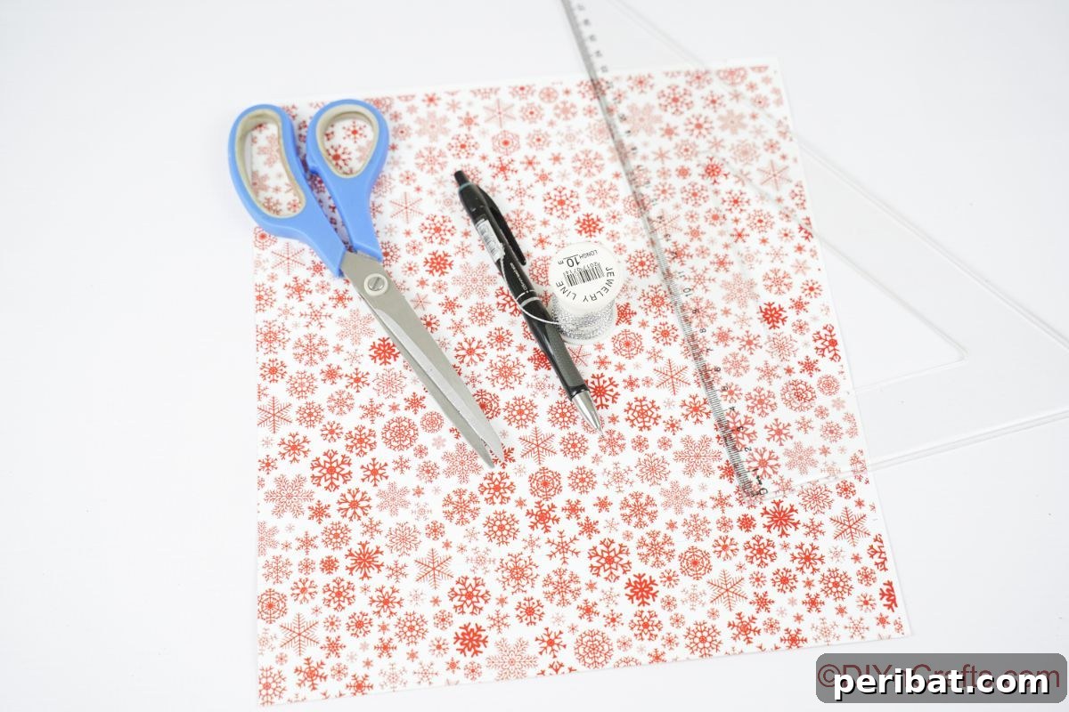 Layered Rolled Paper Christmas Charm 9 red and white scrapbook paper ruler scissors and pen on white table