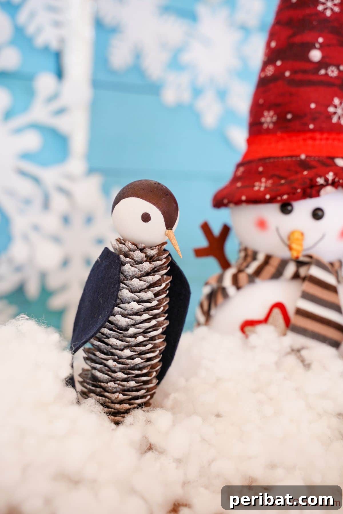 Winter Pinecone Penguin Fun 23 pinecone penguin on fake snow by snowman decoration