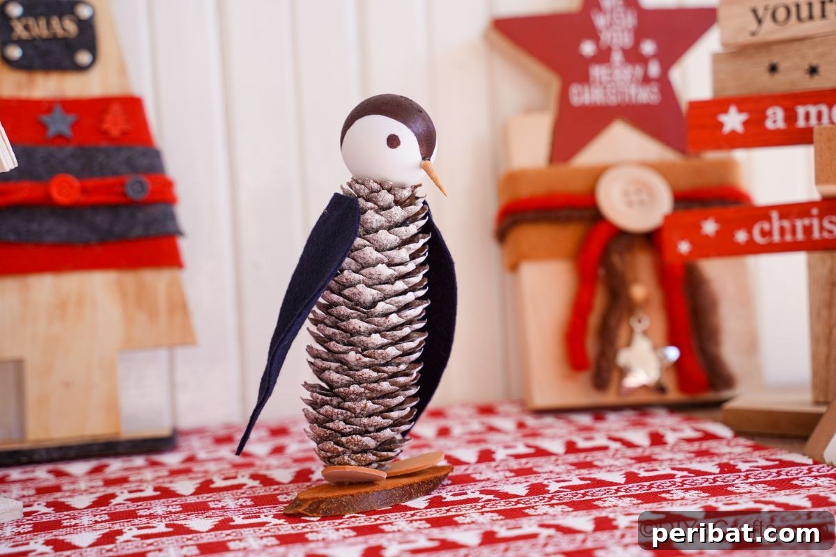 Winter Pinecone Penguin Fun 9 A charming pinecone penguin on festive red and white striped paper, surrounded by blurred holiday decorations, creating a joyful atmosphere.