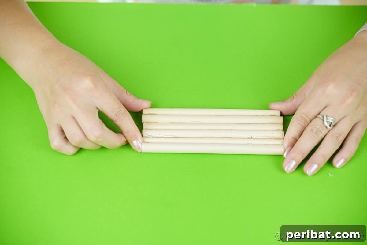 hands holding paper logs together on green table