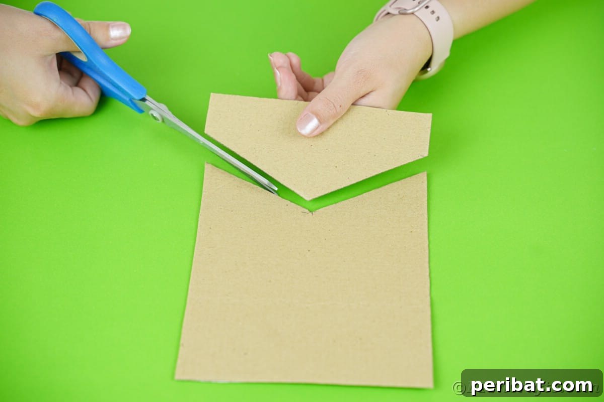 blue scissors cutting cardboard into roof shape