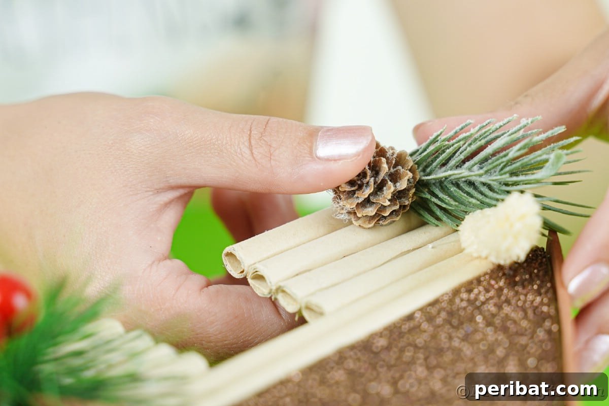 hand holding pinecone onto side of miniature house