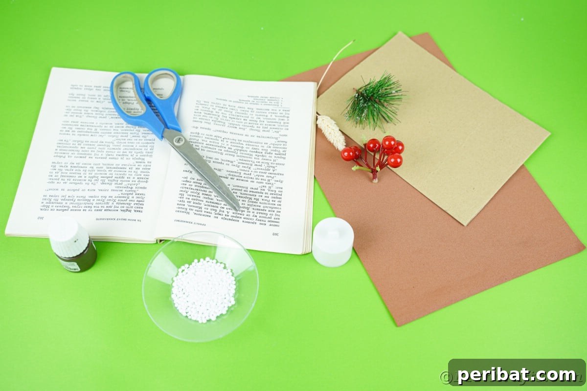 green table with cardboard scissors book pages and brown paper