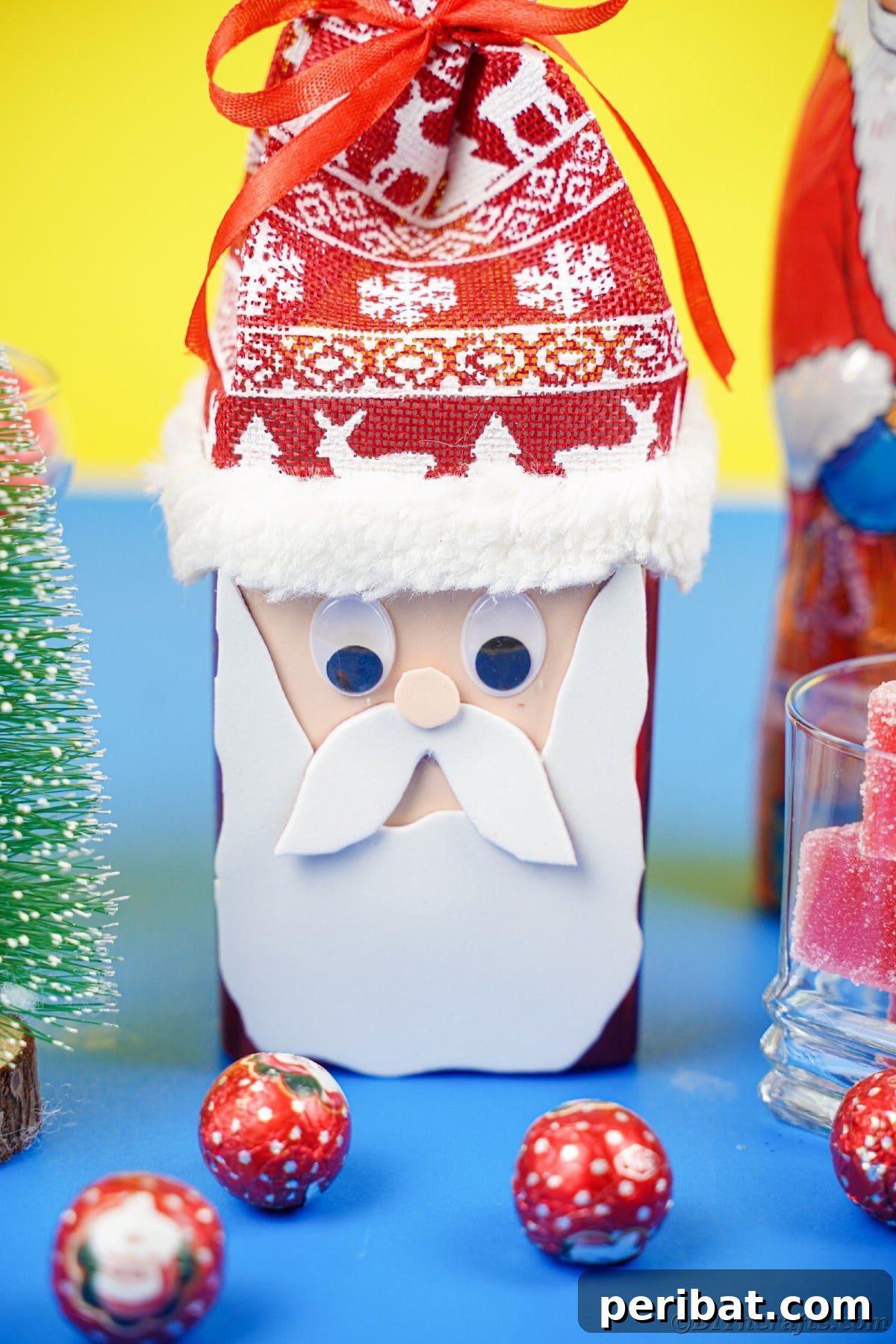 Jolly Upcycled Milk Carton Santa Candy Box 4 Santa Claus candy box filled with colorful ball candies, sitting on a blue table