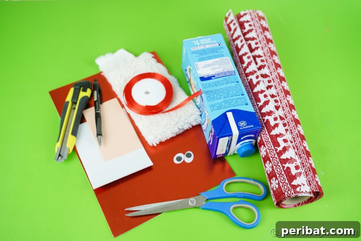 Jolly Upcycled Milk Carton Santa Candy Box 8 Red foam paper, empty carton, scissors, and other craft supplies neatly arranged on a green table