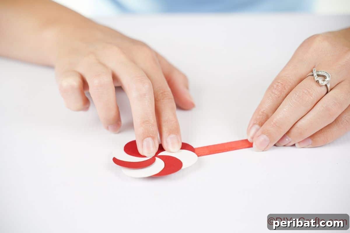 Sweet Peppermint Stick Decor 12 Paper peppermint candy piece securely glued to a red craft stick, forming the lollipop ornament.