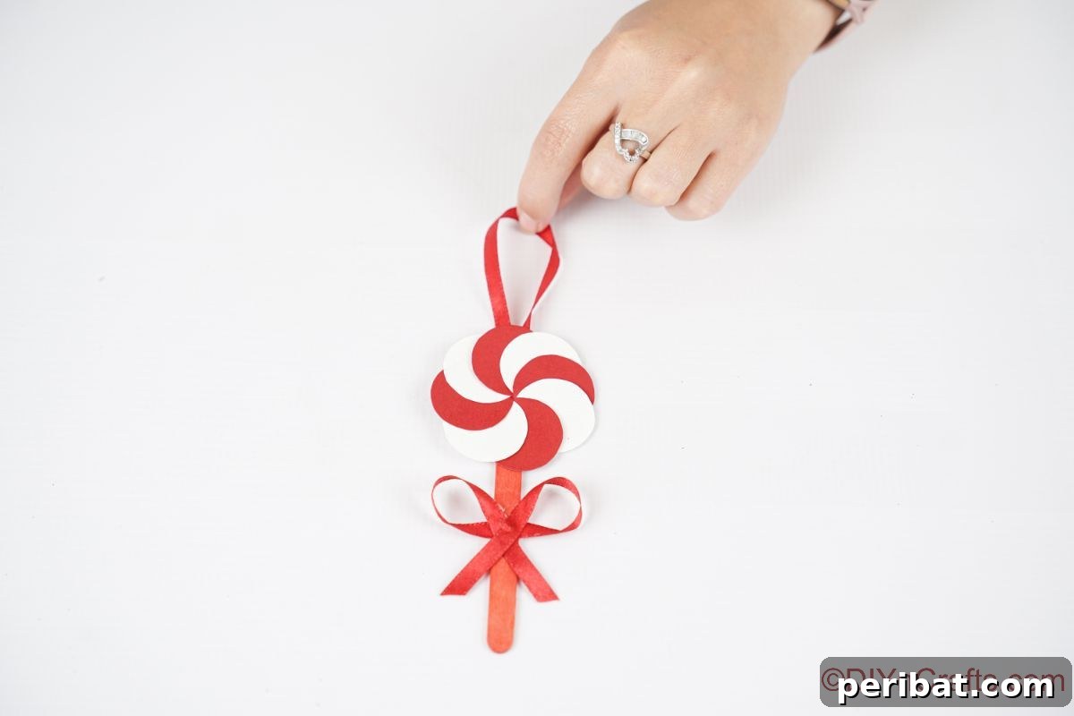 Sweet Peppermint Stick Decor 14 Red and white swirl paper peppermint candy ornament on Christmas tree, the final beautiful display.