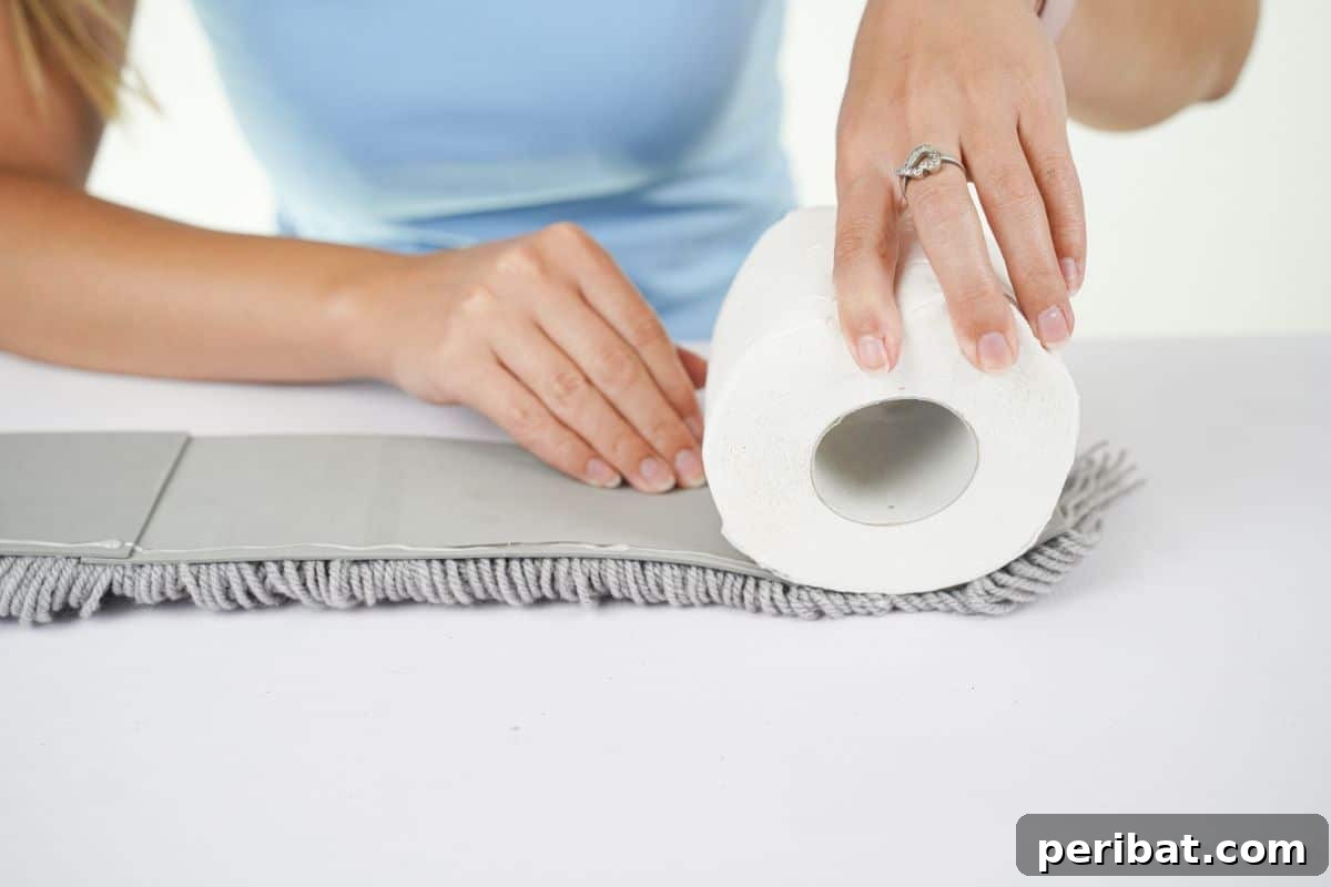 hand rolling yarn base around toilet paper roll