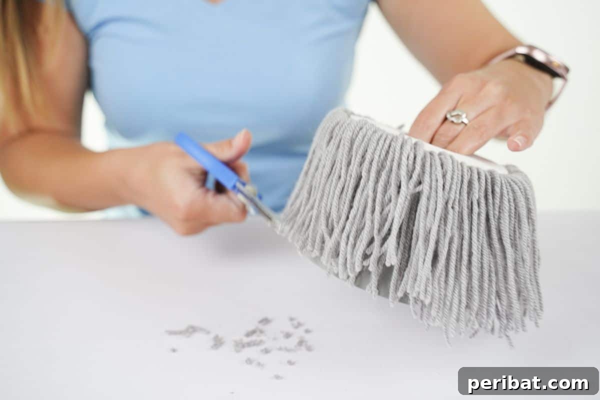 blue scissors trimming ends off gray yarn