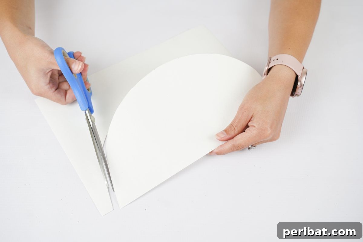 blue scissors cutting white paper half circle