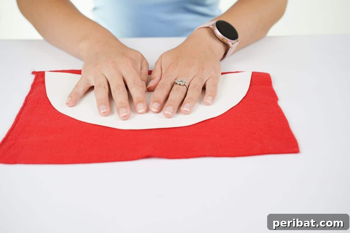 hands holding white paper on top of red felt