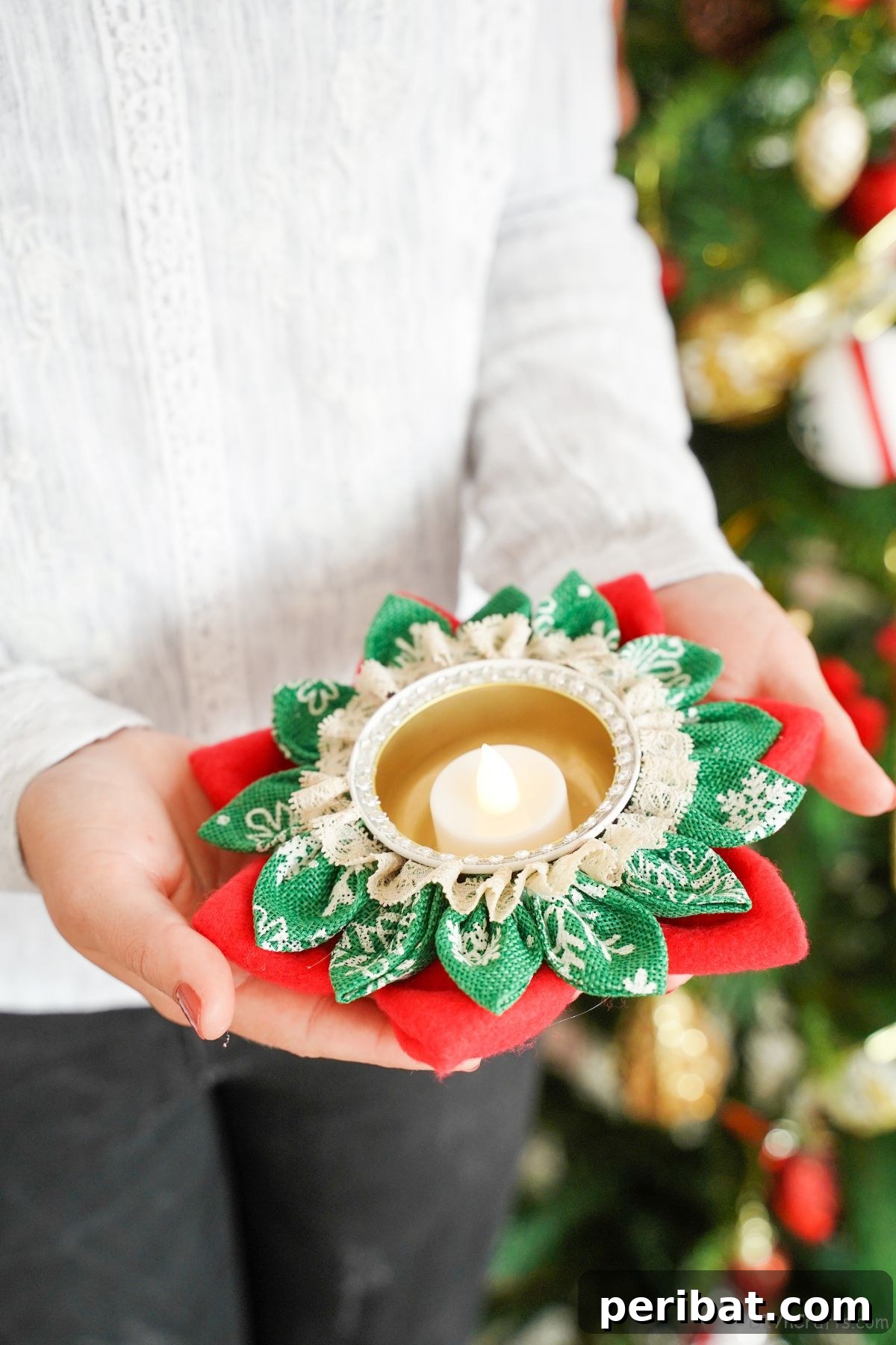 Festive Fabric Floral Candle Centerpiece 2 woman in white sweater holding a flower candle holder