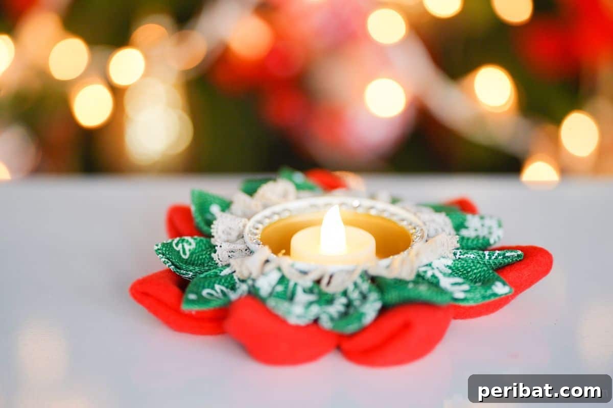 Festive Fabric Floral Candle Centerpiece 3 red and green flower shaped candle holder on white table by tree