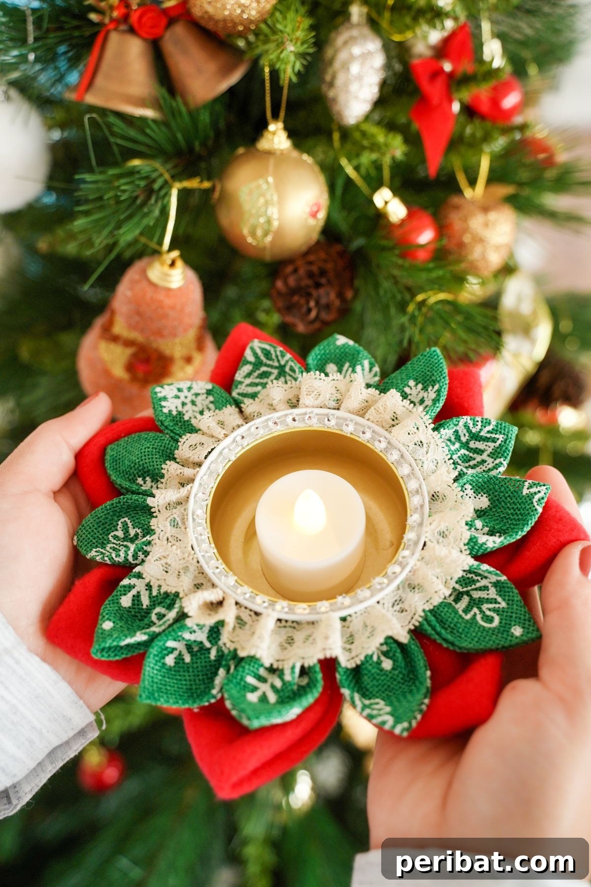 Festive Fabric Floral Candle Centerpiece 16 hands holding flower candle holder by holiday tree