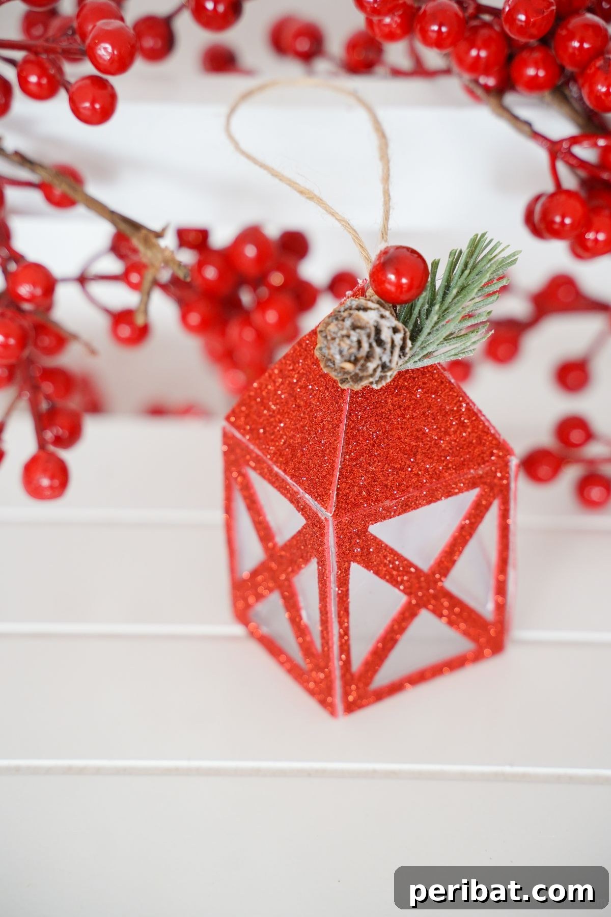 fake paper lantern on white table by fake berries