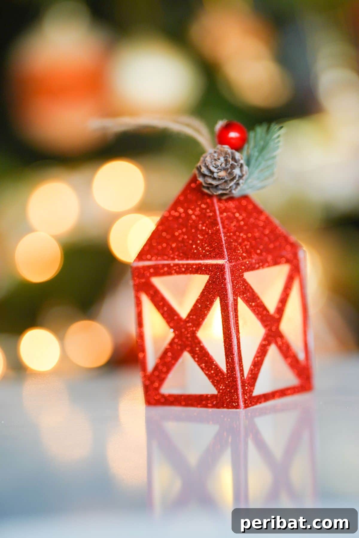red glitter paper lantern on table by Christmas tree