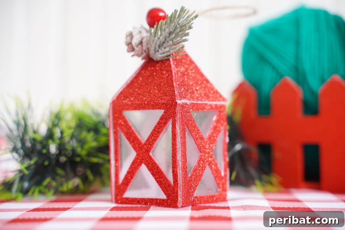 mini paper lantern in front of greenery on red and white checked tablecloth